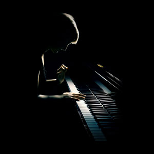 a concert pianist playing a piano